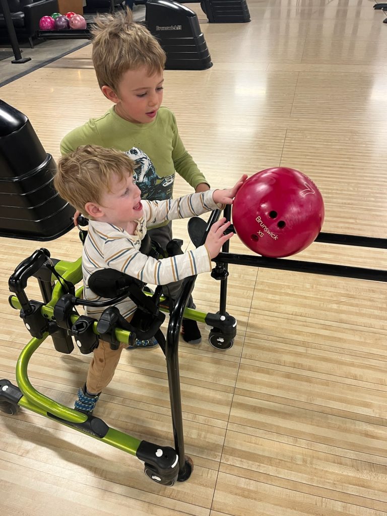 two young children bowling